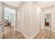 Inviting hallway with wood floors and white trim, leading to various rooms in the home at 2652 Private Lefler Dr, Johns Island, SC 29455
