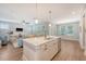 Bright, open-concept kitchen featuring quartz countertops, stainless steel appliances, and hardwood floors at 2652 Private Lefler Dr, Johns Island, SC 29455