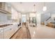 Modern kitchen featuring white cabinets, stainless steel appliances, and a herringbone backsplash at 2652 Private Lefler Dr, Johns Island, SC 29455