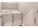 Functional laundry area with washer, dryer, wire shelving, and crisp white appliances at 2652 Private Lefler Dr, Johns Island, SC 29455