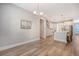 Open floorplan with hardwood floors connects dining area to kitchen with stainless appliances and center island at 2652 Private Lefler Dr, Johns Island, SC 29455