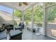Relaxing screened-in porch with comfortable seating and views of the lush backyard at 2652 Private Lefler Dr, Johns Island, SC 29455