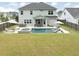 Expansive backyard featuring pool, jacuzzi, outdoor kitchen, lounge chairs, and patio seating at 2802 Cavalcade Cir, Johns Island, SC 29455