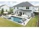 Expansive backyard featuring pool, jacuzzi, outdoor kitchen, lounge chairs, patio seating and green grass at 2802 Cavalcade Cir, Johns Island, SC 29455