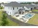 Spacious backyard featuring pool, jacuzzi, outdoor kitchen, lounge chairs, and patio seating with privacy fence at 2802 Cavalcade Cir, Johns Island, SC 29455