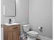 Neutral powder room with stylish vanity, modern fixtures, and tiled floors for a sleek design at 2802 Cavalcade Cir, Johns Island, SC 29455