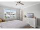 Bright bedroom with light hardwood flooring, featuring a large window and modern decor at 2802 Cavalcade Cir, Johns Island, SC 29455