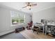 Bright bedroom with wood floors, a ceiling fan, exercise equipment and a computer desk at 2802 Cavalcade Cir, Johns Island, SC 29455