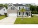 Charming two-story home featuring a two-car garage, landscaped yard and welcoming front porch at 2802 Cavalcade Cir, Johns Island, SC 29455