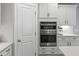Modern kitchen with stainless steel double oven and sleek white cabinetry for a seamless design at 2802 Cavalcade Cir, Johns Island, SC 29455