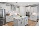 Modern kitchen with white cabinets, stainless steel appliances, and a center island at 2802 Cavalcade Cir, Johns Island, SC 29455