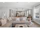 Bright living room featuring a large sectional sofa and an open layout to the kitchen at 2802 Cavalcade Cir, Johns Island, SC 29455