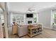 Bright living room with fireplace, ceiling fan, modern decor, wood floors, side table and lots of natural light at 2802 Cavalcade Cir, Johns Island, SC 29455