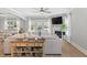 Bright living room with fireplace, ceiling fan, modern decor, wood floors and lots of natural light at 2802 Cavalcade Cir, Johns Island, SC 29455