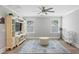 Bright living room featuring wood floors, white trim, built-in storage and a ceiling fan at 2802 Cavalcade Cir, Johns Island, SC 29455