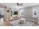 Bright living room featuring wood floors, white trim, built-in storage and large windows at 2802 Cavalcade Cir, Johns Island, SC 29455