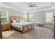 A well-lit main bedroom featuring a decorative rug, windows and a ceiling fan at 2802 Cavalcade Cir, Johns Island, SC 29455