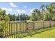 Lush backyard features a charming fence and a serene pond view, creating a private outdoor oasis at 2820 Merriams Dr, Charleston, SC 29414