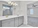 Bathroom featuring a dual sink vanity, large mirror, and tiled shower stall at 2820 Merriams Dr, Charleston, SC 29414
