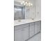 Bathroom featuring a dual sink vanity, large mirror, and tiled shower stall at 2820 Merriams Dr, Charleston, SC 29414