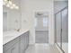 Bathroom featuring a dual sink vanity, large mirror, and tiled shower stall at 2820 Merriams Dr, Charleston, SC 29414