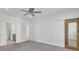 Spacious bedroom featuring neutral carpet, ceiling fan, and a sliding barn door at 2820 Merriams Dr, Charleston, SC 29414
