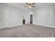 Bright bedroom with neutral carpet, ceiling fan, white trim, and doorways to other rooms at 2820 Merriams Dr, Charleston, SC 29414