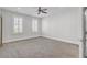 Bright bedroom with neutral carpet, modern ceiling fan, and shuttered windows at 2820 Merriams Dr, Charleston, SC 29414