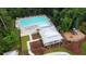 Stunning aerial view of a luxurious community pool, sun deck, and playground, surrounded by lush greenery at 2820 Merriams Dr, Charleston, SC 29414