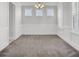 Well-lit dining room with carpet, three windows, stylish chandelier, and classic wainscoting for elegant meals at 2820 Merriams Dr, Charleston, SC 29414
