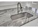 Kitchen island featuring granite countertops, a stainless steel sink, and a modern faucet at 2820 Merriams Dr, Charleston, SC 29414