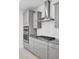 Modern kitchen with stainless steel hood over a cooktop and gray cabinets at 2820 Merriams Dr, Charleston, SC 29414
