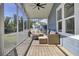 This screened-in porch includes an outdoor living area with stylish furniture and a modern fire pit at 2820 Merriams Dr, Charleston, SC 29414
