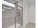 Modern shower with tiled surround, glass door, and updated shower head at 2820 Merriams Dr, Charleston, SC 29414