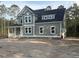 Two-story home featuring sage green siding, white trim, and charming dark shutters at 3006 Sweetwater Ln, Awendaw, SC 29429