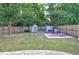 Spacious backyard featuring a privacy fence, green lawn, two storage sheds and patio furniture at 3009 Mapleleaf Dr, Moncks Corner, SC 29461