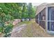 View of the fenced backyard, showing a screened-in porch and two sheds for outdoor storage at 3009 Mapleleaf Dr, Moncks Corner, SC 29461