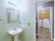 Cozy half bathroom with pedestal sink and framed mirror at 3009 Mapleleaf Dr, Moncks Corner, SC 29461