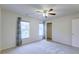 Spacious bedroom featuring neutral carpet, a ceiling fan, and two large windows with bright natural light at 3009 Mapleleaf Dr, Moncks Corner, SC 29461