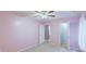 Carpeted bedroom with pastel pink walls, a ceiling fan and several door openings at 3009 Mapleleaf Dr, Moncks Corner, SC 29461