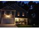 Well-lit two-story home with a two-car garage and well-manicured landscaping at night at 3009 Mapleleaf Dr, Moncks Corner, SC 29461