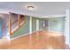 Spacious living room features wood floors, stairs with wood railings, and neutral wall paint at 3009 Mapleleaf Dr, Moncks Corner, SC 29461
