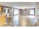 Living room with stone-patterned floors, a ceiling fan, and multiple windows and doorways at 3009 Mapleleaf Dr, Moncks Corner, SC 29461