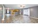 Open-concept living room flowing into the kitchen, featuring wood floors and neutral-colored walls at 3009 Mapleleaf Dr, Moncks Corner, SC 29461