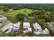 Aerial view of a new neighborhood, featuring newly built homes with manicured lawns and trees at 3023 Eventide Dr, Johns Island, SC 29455