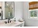 Modern bathroom with black hardware, window and glass-enclosed shower at 3023 Eventide Dr, Johns Island, SC 29455