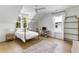 A bright bedroom with a four-poster bed, wood floors, a desk, and lots of light at 3023 Eventide Dr, Johns Island, SC 29455