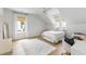 Bright bedroom with white walls, wood floors, a comfortable bed, a makeup table and chair, and lots of light at 3023 Eventide Dr, Johns Island, SC 29455