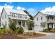 Inviting home showcasing its charming covered porch, well-manicured landscaping, and convenient two-car garage at 3023 Eventide Dr, Johns Island, SC 29455