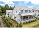Beautiful two-story home with a metal roof, covered porch, and screened-in porch at 3023 Eventide Dr, Johns Island, SC 29455